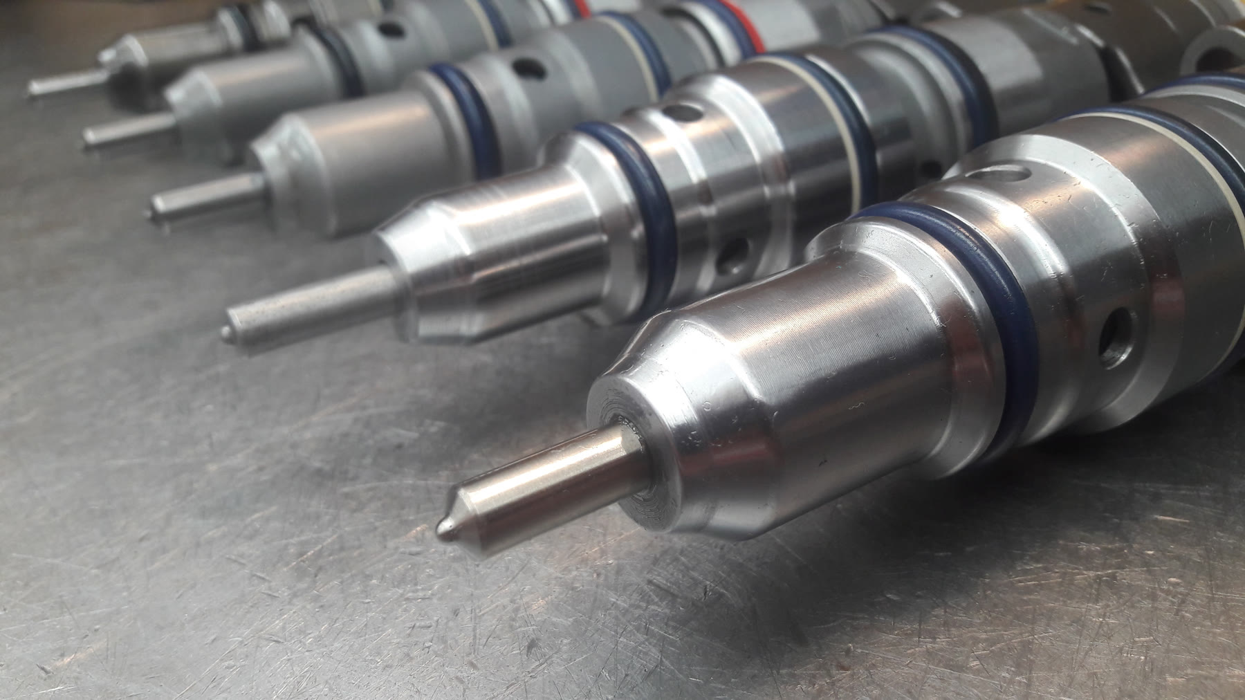 Reconditioned diesel fuel injectors laid out after calibration