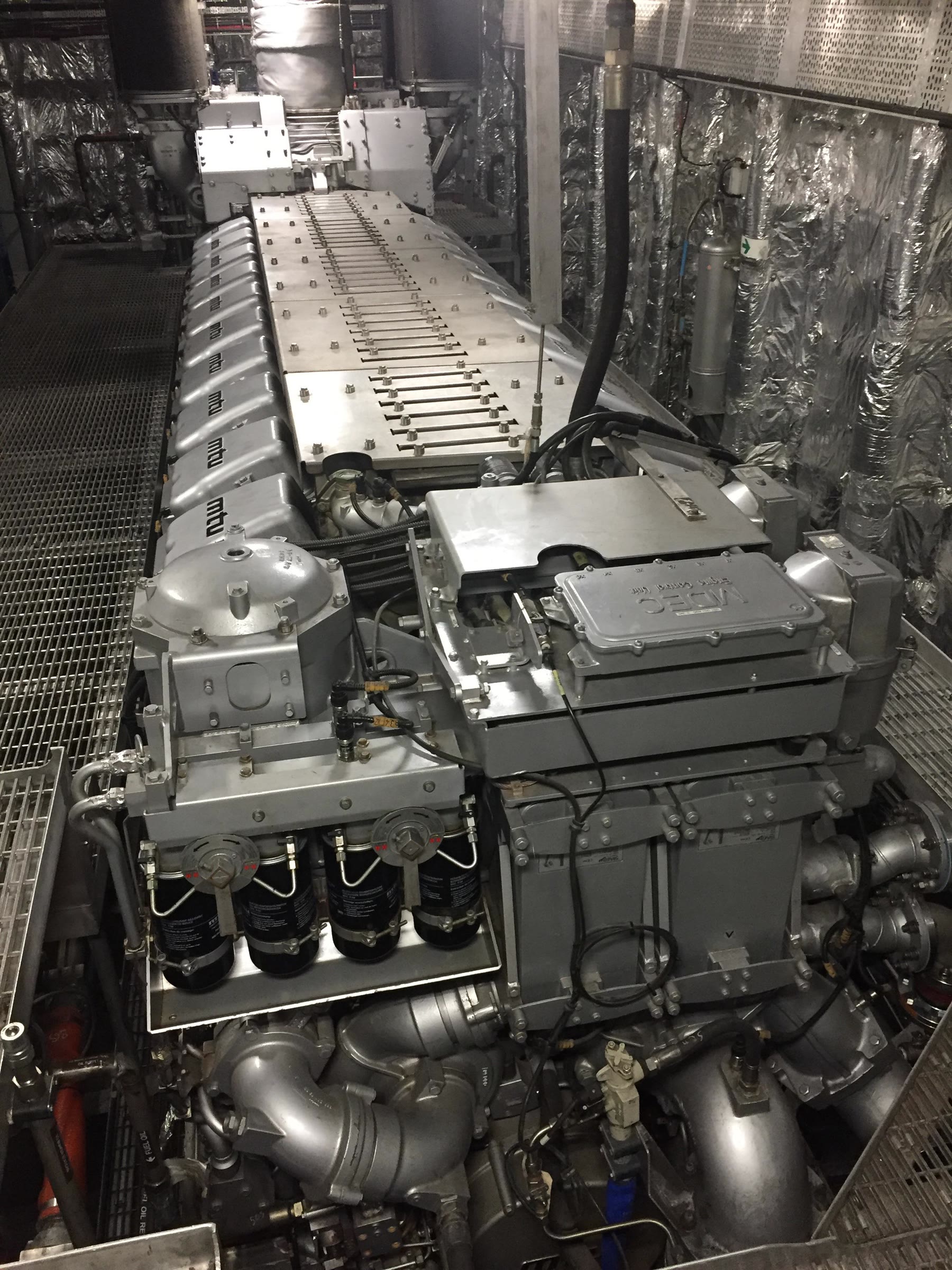 Marine auxiliary diesel engine installed in a vessel engine room