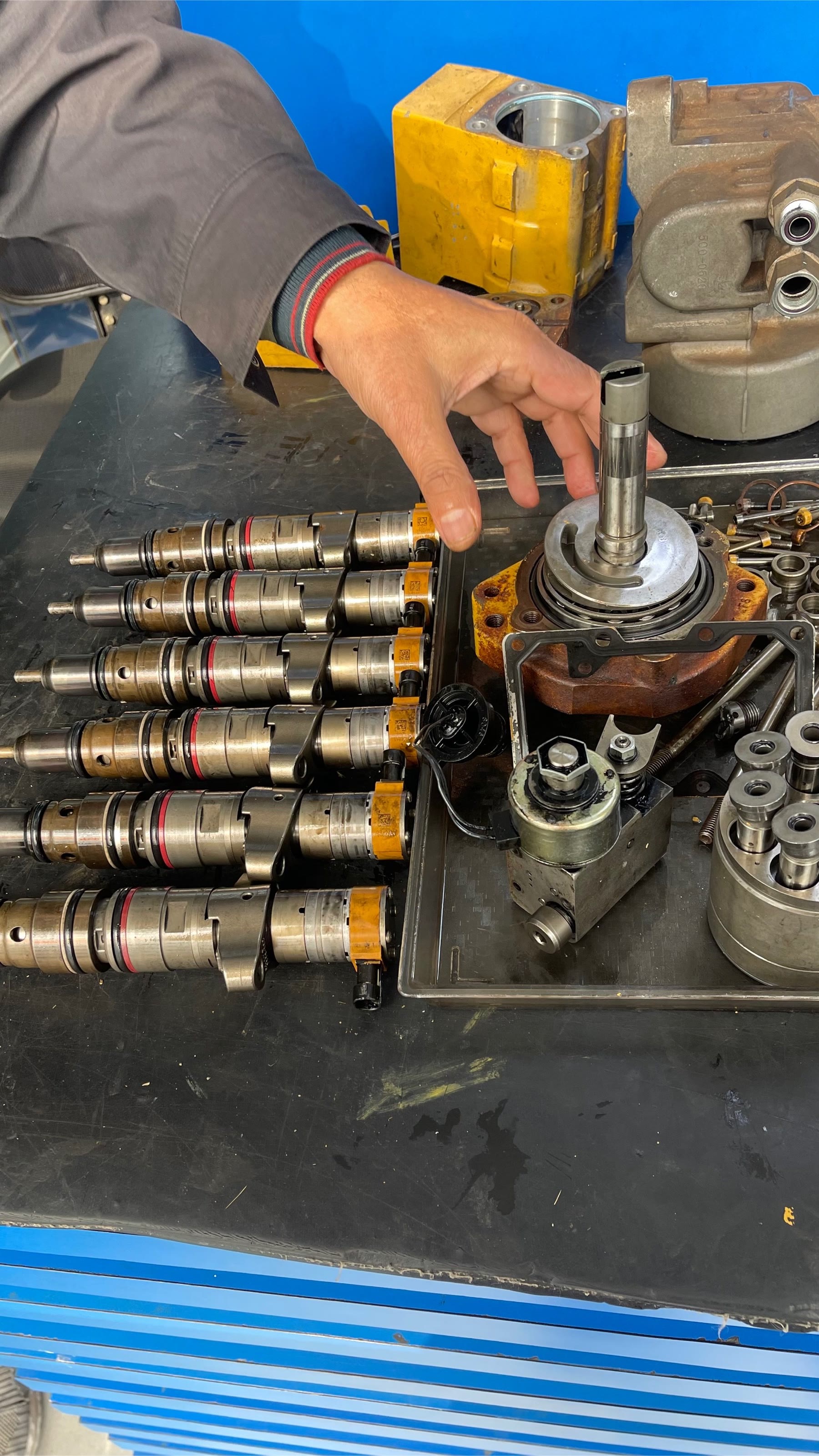 Diesel injector and pump components being inspected at the bench