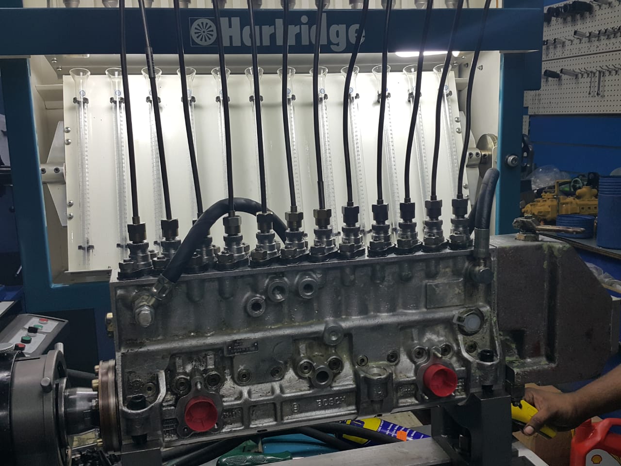 Large multi-element injection pump mounted on a calibration bench