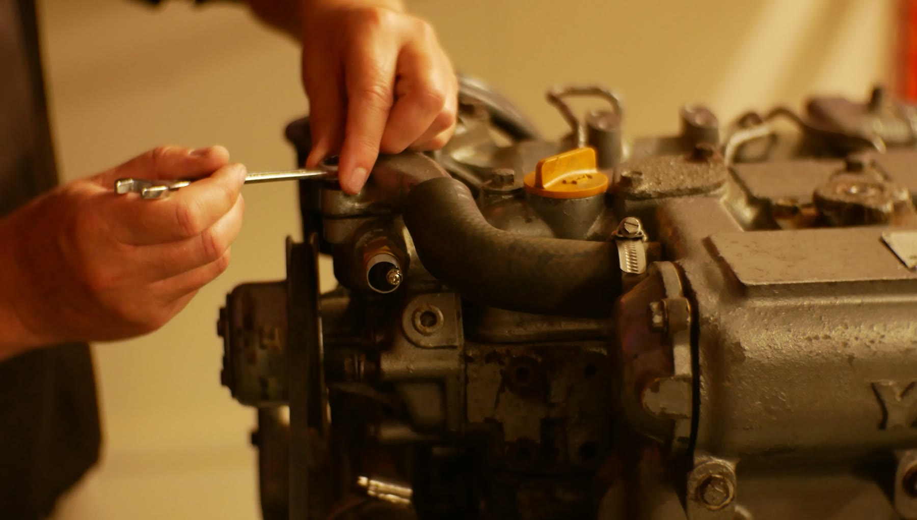 Hands carrying out adjustment work on a diesel injection pump and governor
