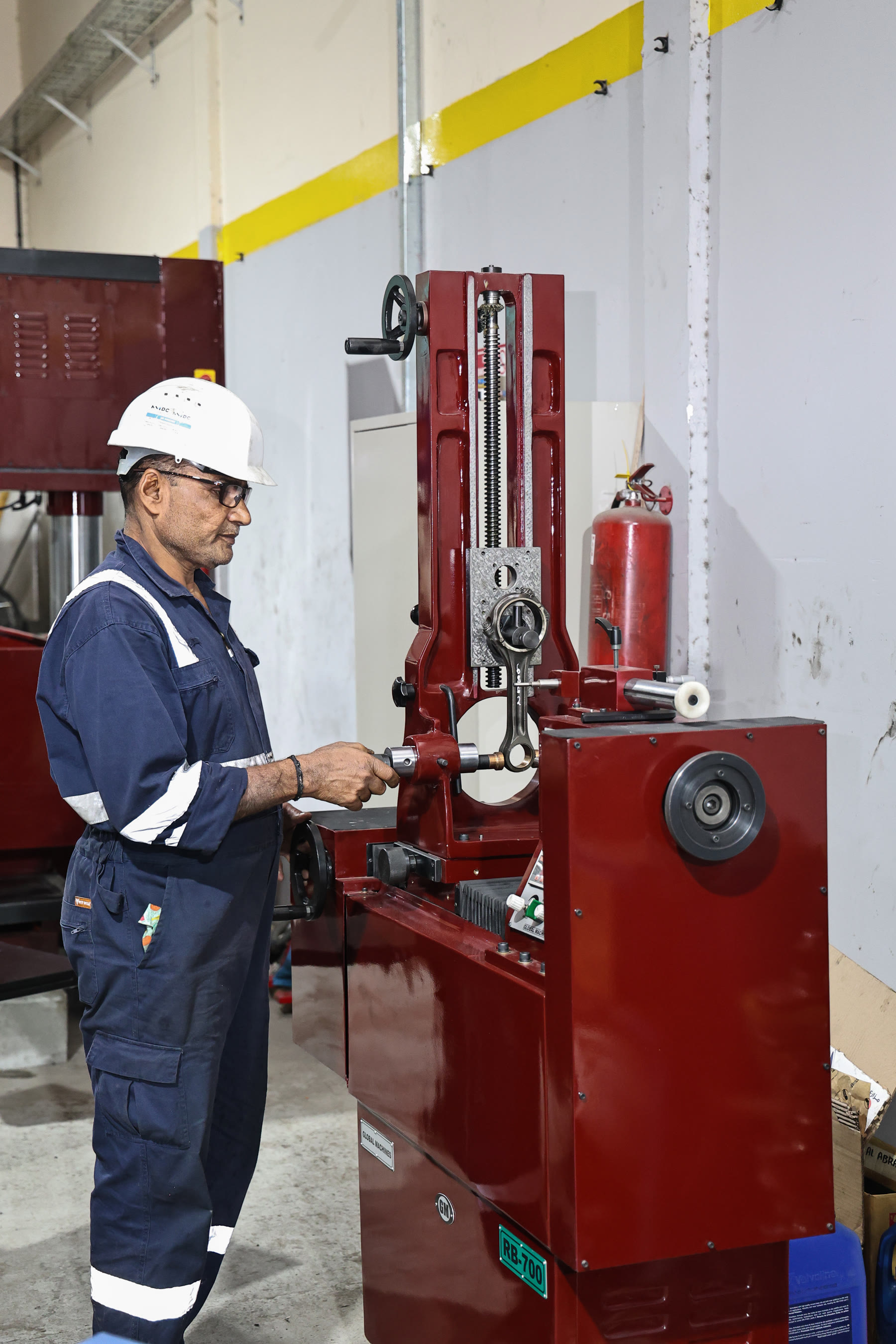 Technician operating the connecting-rod boring machine at Abra Diesel