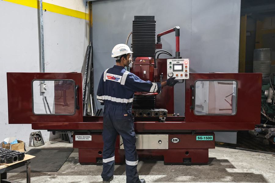 Technician operating machining equipment