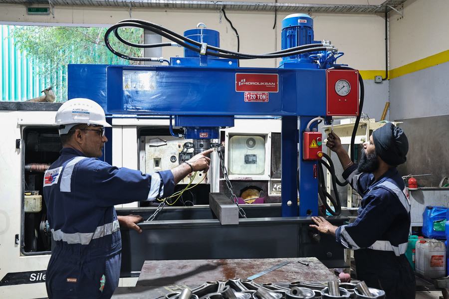 Technician assessing a component at the bench
