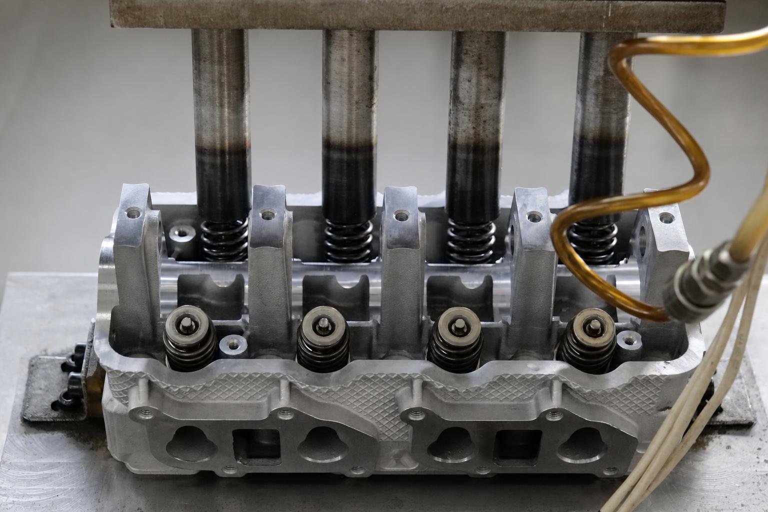 Cylinder head with valve springs and guides visible during bench assembly